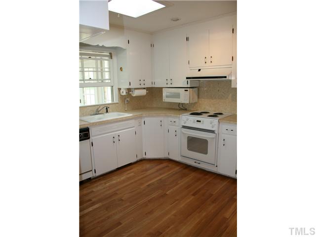 3221 Manor Ridge Drive Raleigh, NC 27603 - Photo 8 of 20 a kitchen with stainless steel appliances granite countertop a stove top oven and sink