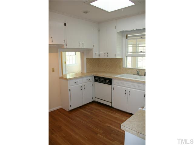 3221 Manor Ridge Drive Raleigh, NC 27603 - Photo 9 of 20 a kitchen with a cabinets and window