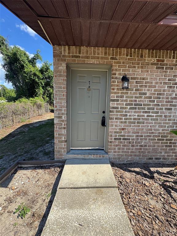 1195 Bentley Road, Unit 1 Leesburg, FL 34748 - Photo 2 of 13 a view of door with yard