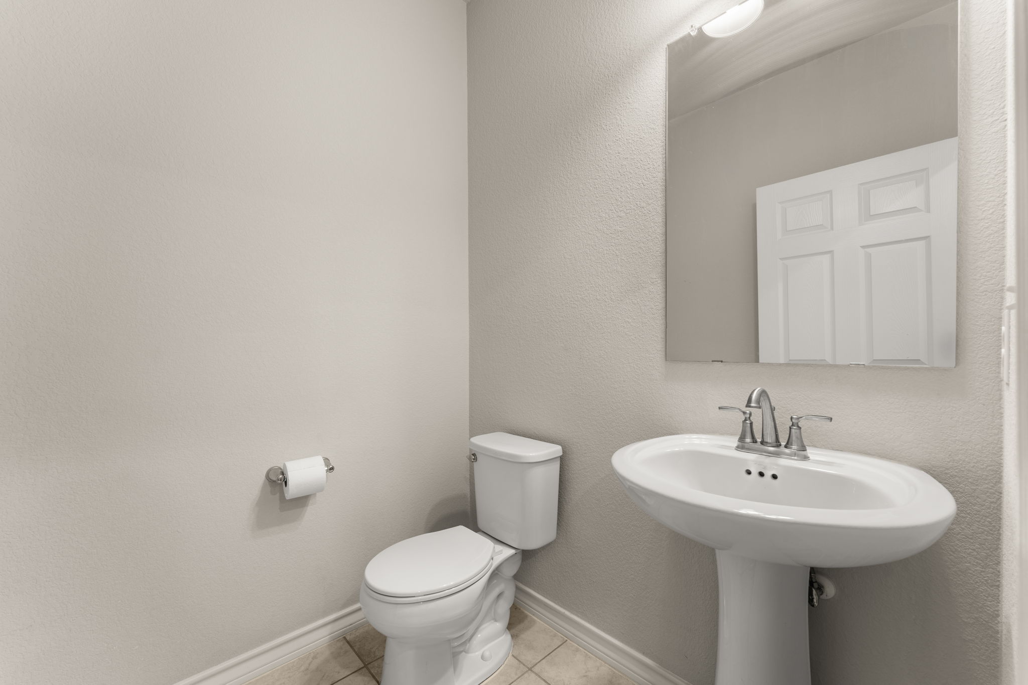 740 Aliso Trail Leander, TX 78641 - Photo 20 of 35 The main-floor powder room offers a convenient and private space for guests with easy access from the common areas.