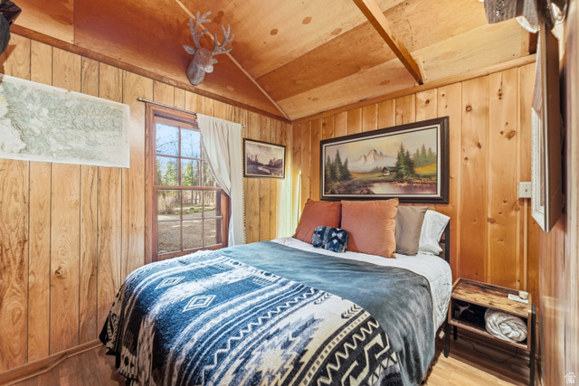 6631 Pine Springs Road Kamas, UT 84036 - Photo 10 of 48 Bedroom featuring wood finished floors, wood walls, and a vaulted wooden ceiling