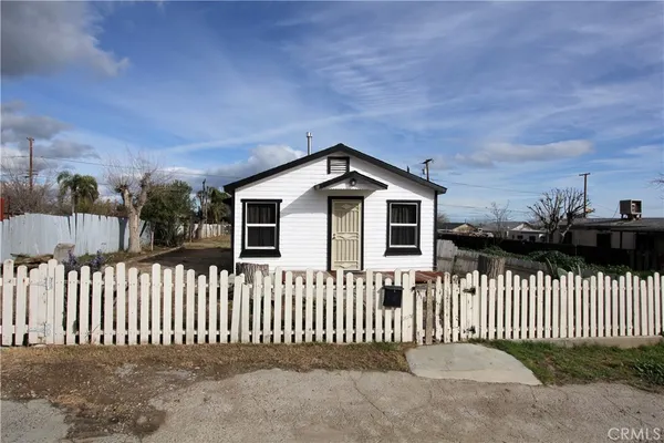 a front view of a house with a fence