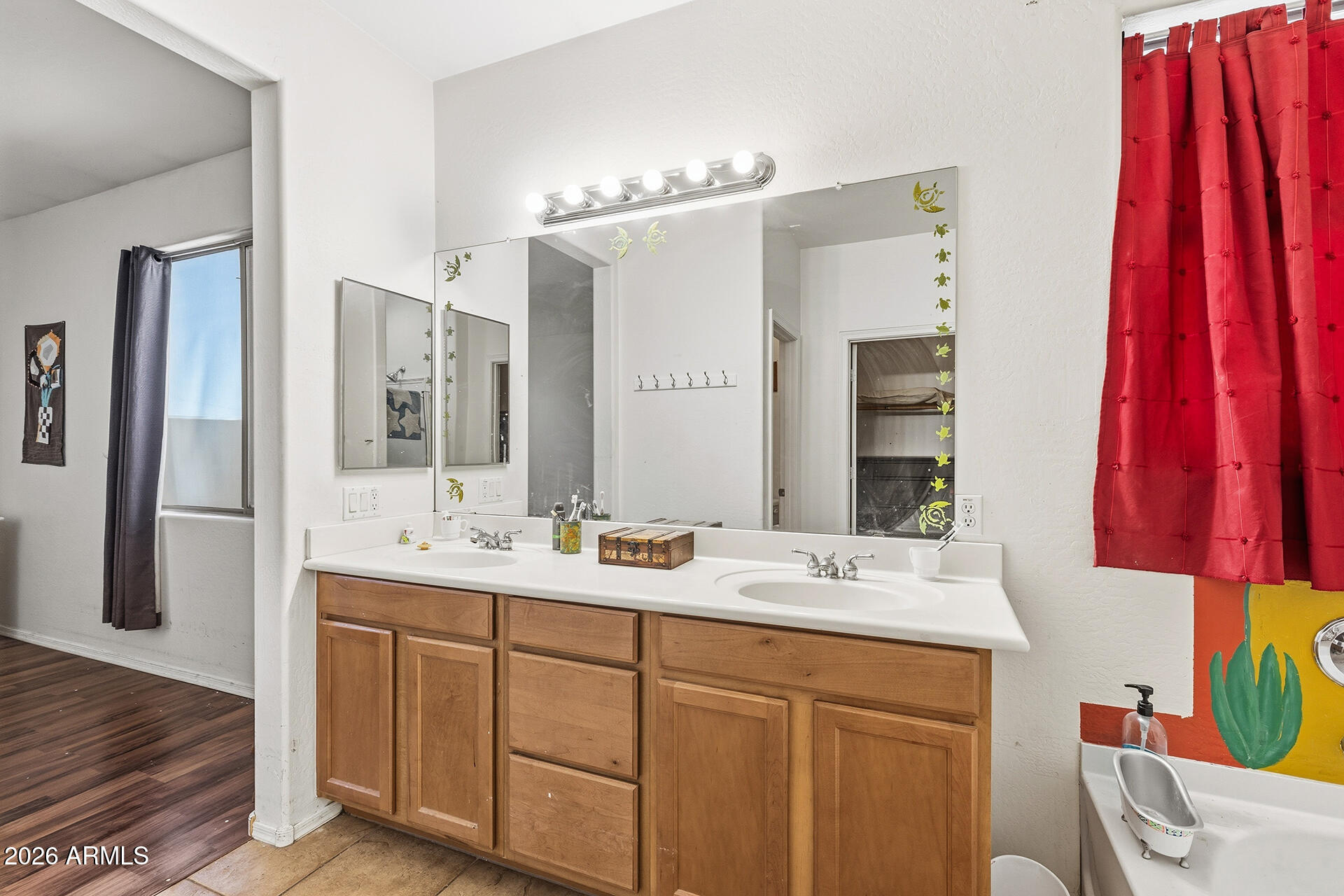 6718 West Darrel Road Laveen, AZ 85339 - Photo 9 of 49 a bathroom with a double vanity sink and a mirror