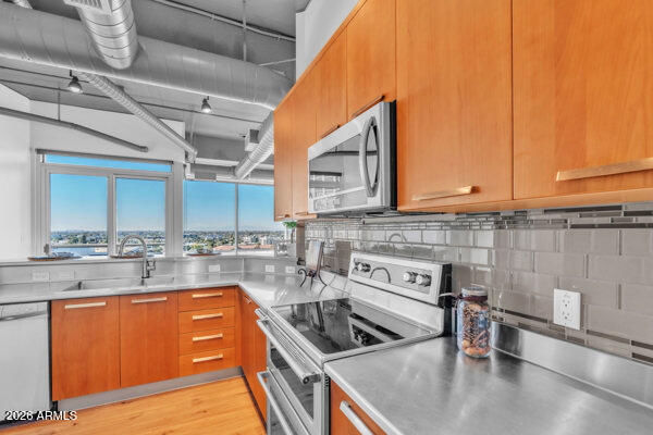 1 East Lexington Avenue, Unit 809 Phoenix, AZ 85012 - Photo 12 of 44 a kitchen with stainless steel appliances granite countertop a sink and a stove