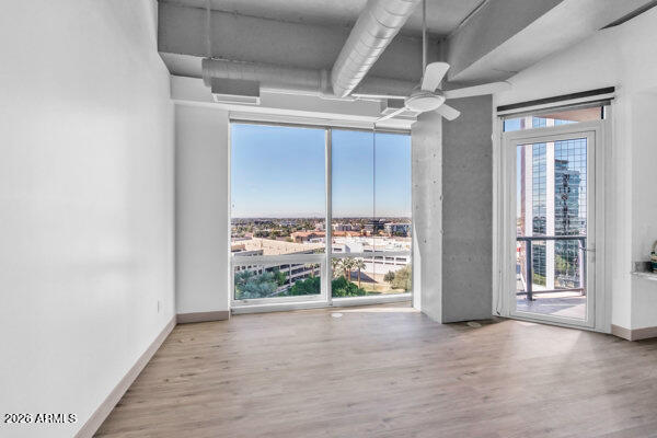 1 East Lexington Avenue, Unit 809 Phoenix, AZ 85012 - Photo 14 of 44 an empty room with wooden floor and windows