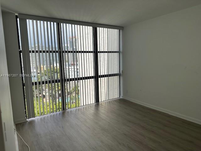 17021 North Bay Road, Unit 904 Sunny Isles Beach, FL 33160 - Photo 11 of 18 en empty room with wooden floor and windows
