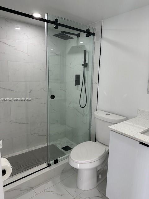 17021 North Bay Road, Unit 904 Sunny Isles Beach, FL 33160 - Photo 15 of 18 a bathroom with a shower a toilet and a sink
