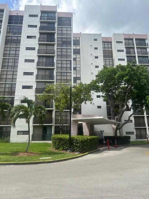 17021 North Bay Road, Unit 904 Sunny Isles Beach, FL 33160 - Photo 2 of 18 a front view of a building with a garden and plants