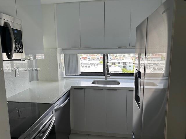 17021 North Bay Road, Unit 904 Sunny Isles Beach, FL 33160 - Photo 10 of 18 a kitchen with stainless steel appliances granite countertop a sink and a refrigerator