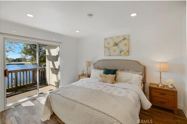 a bedroom with a bed and painting on the wall