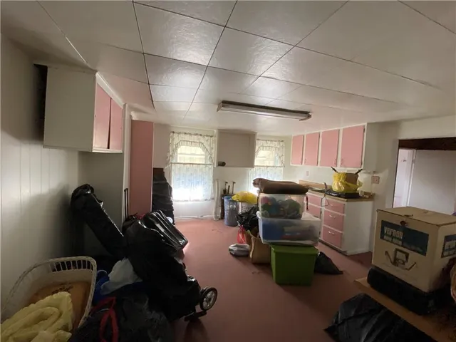 a white house that has tree in front of it