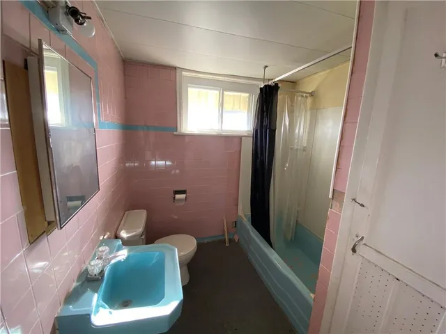 a view of a yard in front of a house with large trees