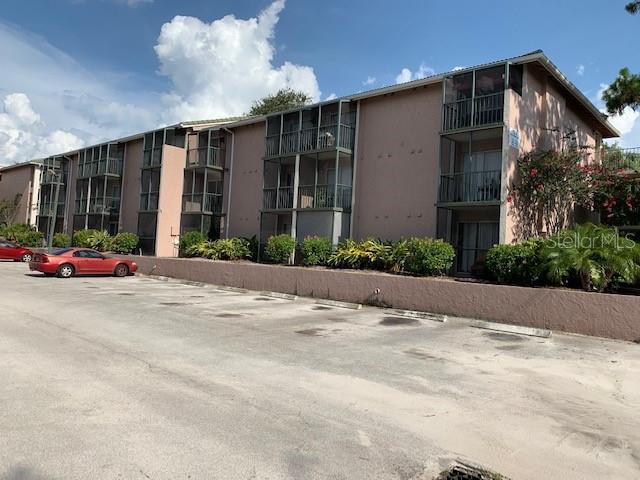 128 Water Front Way, Unit 220 Altamonte Springs, FL 32701 - Photo 1 of 1 a front view of a house with a yard and a garage