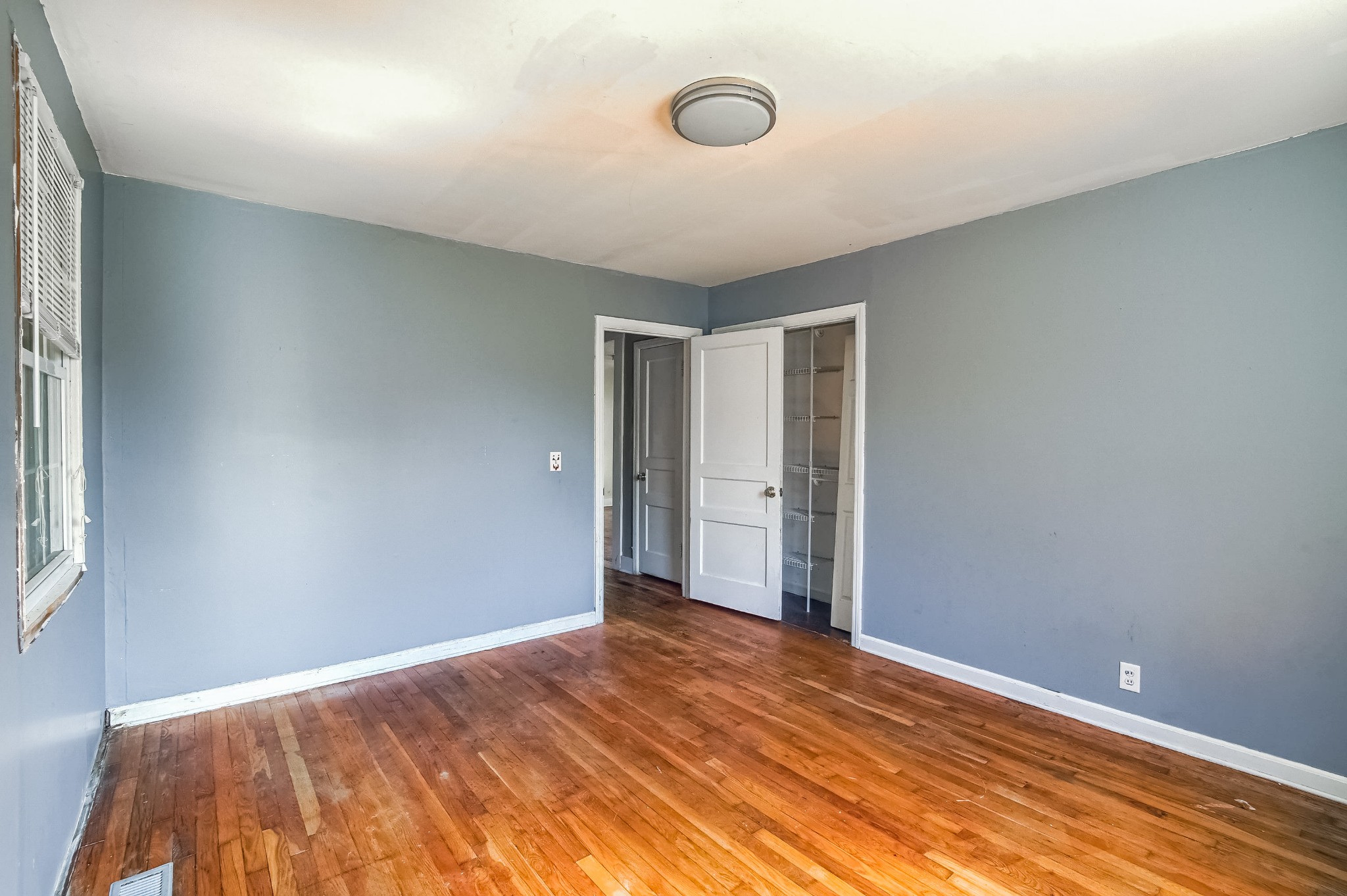 324 Randy Road Madison, TN 37115 - Photo 8 of 13 a view of an empty room with wooden floor and a window
