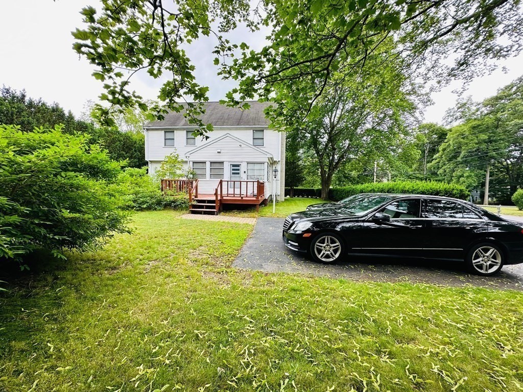 143 Reed Street Lexington, MA 02421 - Photo 5 of 19 a view of a car parked in front of a house