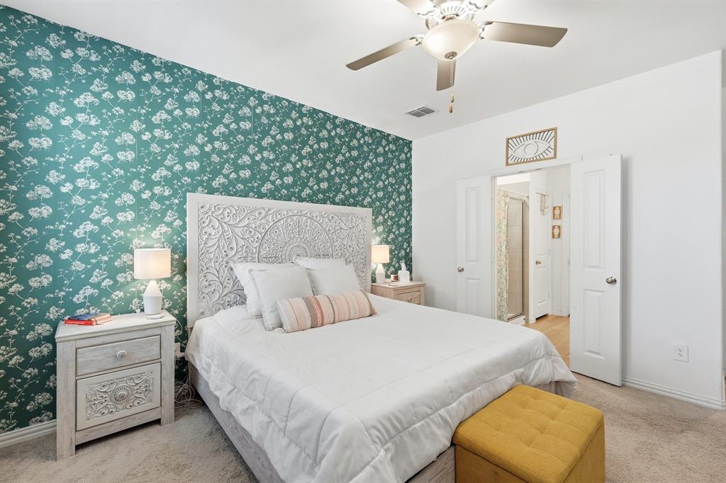 528 Ranchito Pass Fort Worth, TX 76052 - Photo 12 of 28 a bedroom with a bed and a chandelier