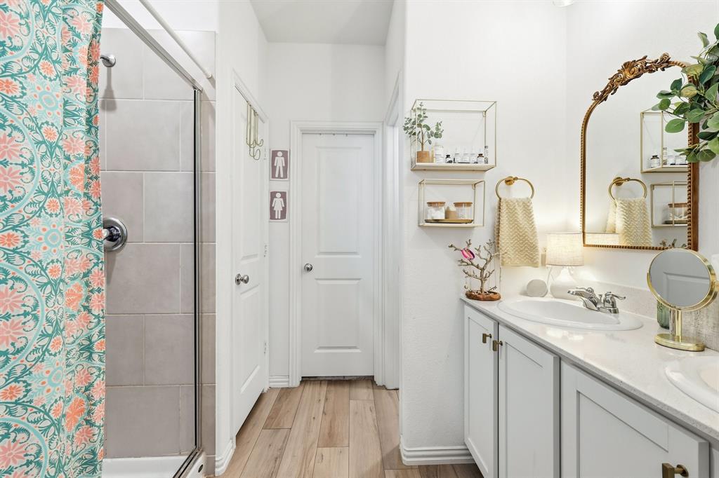 528 Ranchito Pass Fort Worth, TX 76052 - Photo 14 of 28 a bathroom with a sink a mirror and a shower curtain