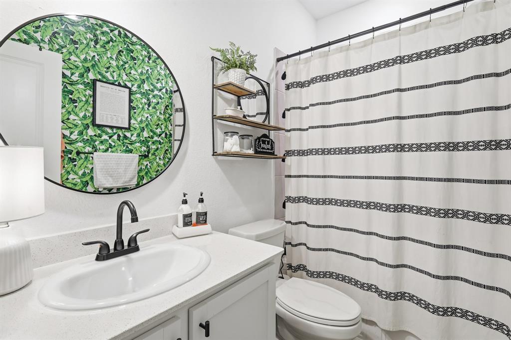 528 Ranchito Pass Fort Worth, TX 76052 - Photo 17 of 28 a bathroom with a sink and a mirror