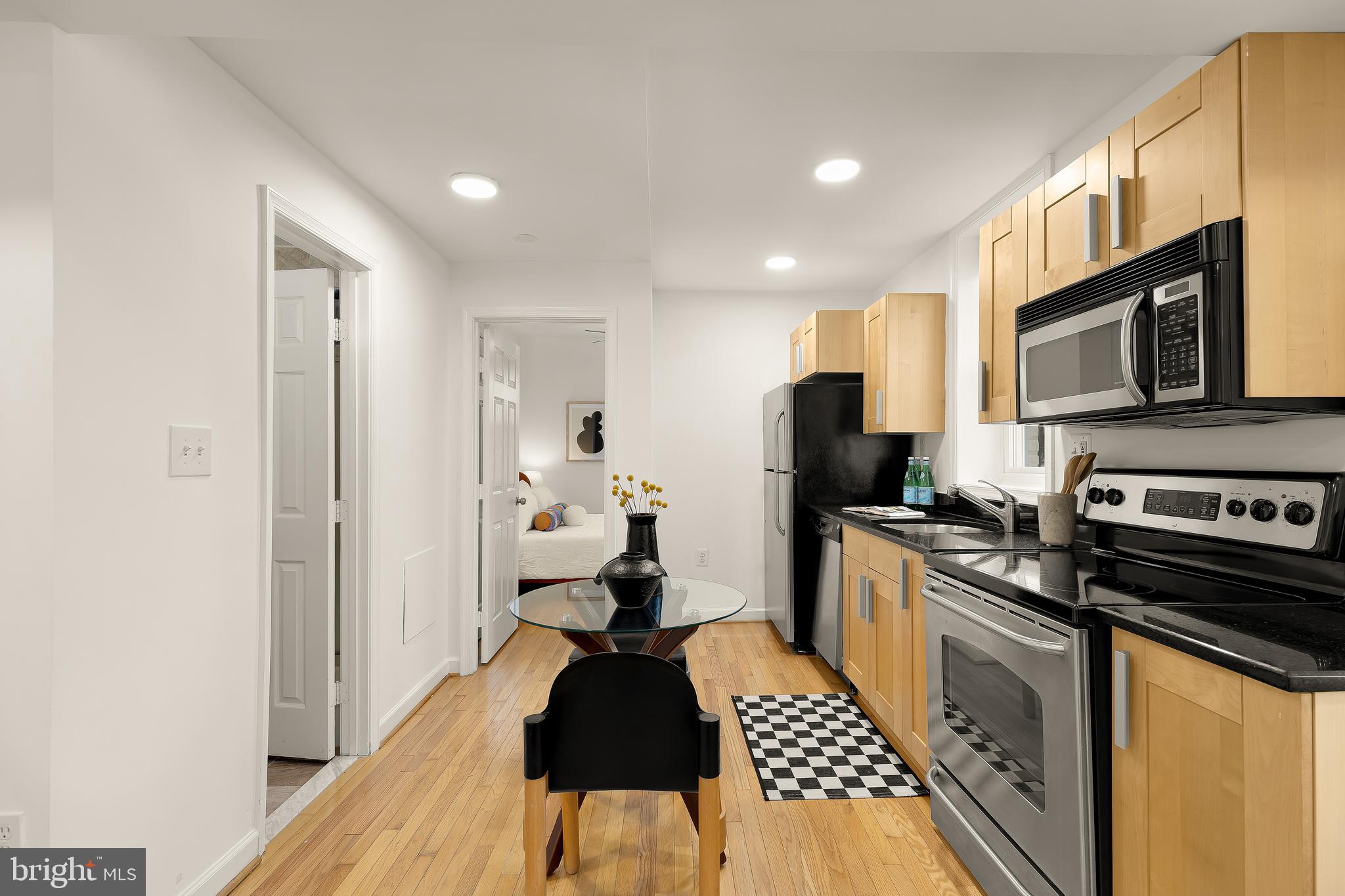 314 V Street Northeast, Unit 204 Washington, DC 20002 - Photo 4 of 13 a kitchen with stainless steel appliances a refrigerator stove microwave and cabinets