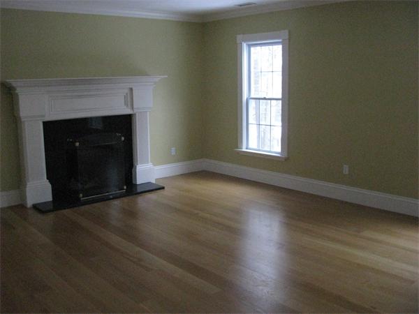 546 Fowler Road Northbridge, MA 01534 - Photo 3 of 11 an empty room with wooden floor and fireplace