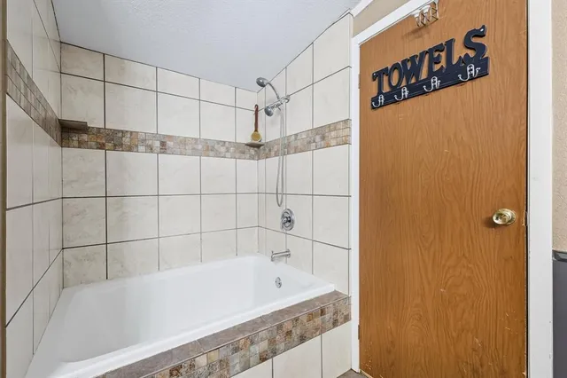 a bathroom with a bathtub and shower