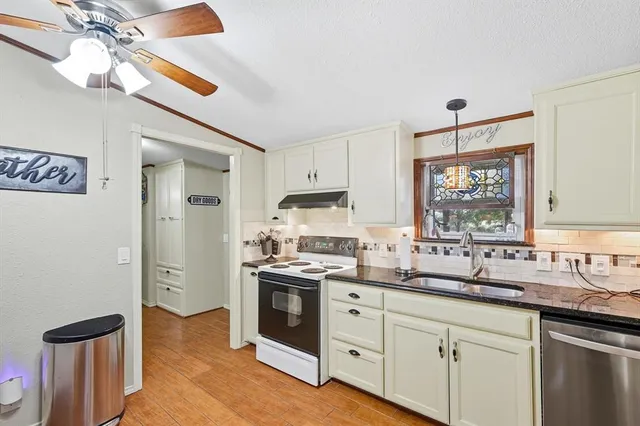 a kitchen with a sink cabinets and window