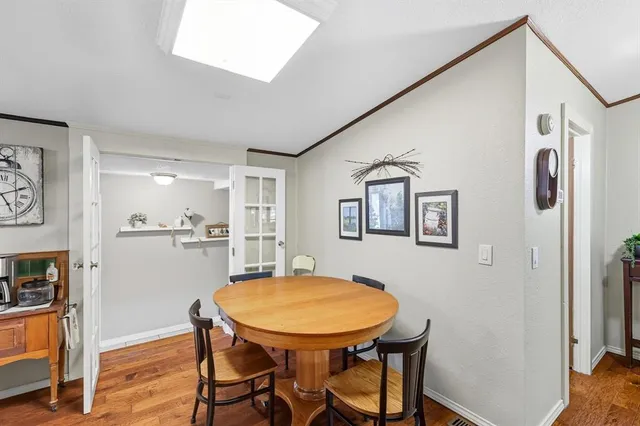 a view of a dining room with furniture and a kitchen
