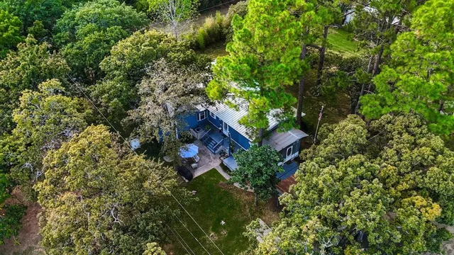 an aerial view of a house with a yard