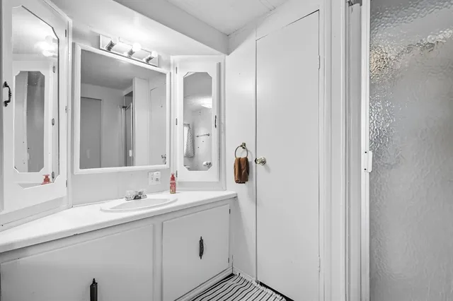 a bathroom with a double vanity sink mirror and double