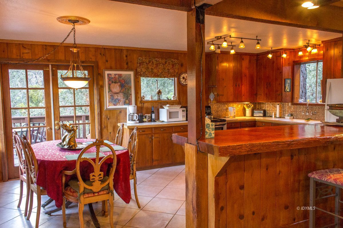 25120 Foster Lake Road Idyllwild, CA 92549 - Photo 11 of 31 a dining room filled with lots of furniture and chandelier