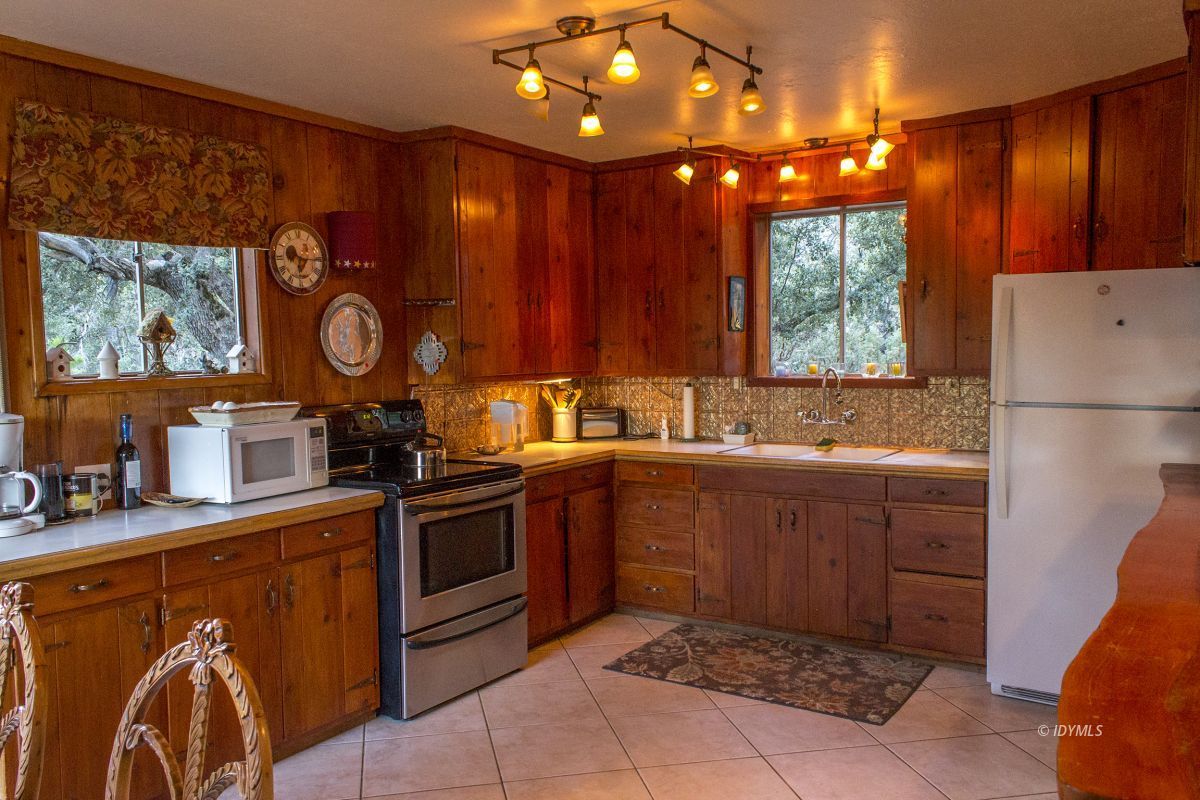 25120 Foster Lake Road Idyllwild, CA 92549 - Photo 14 of 31 a kitchen with stainless steel appliances granite countertop a sink stove and cabinets