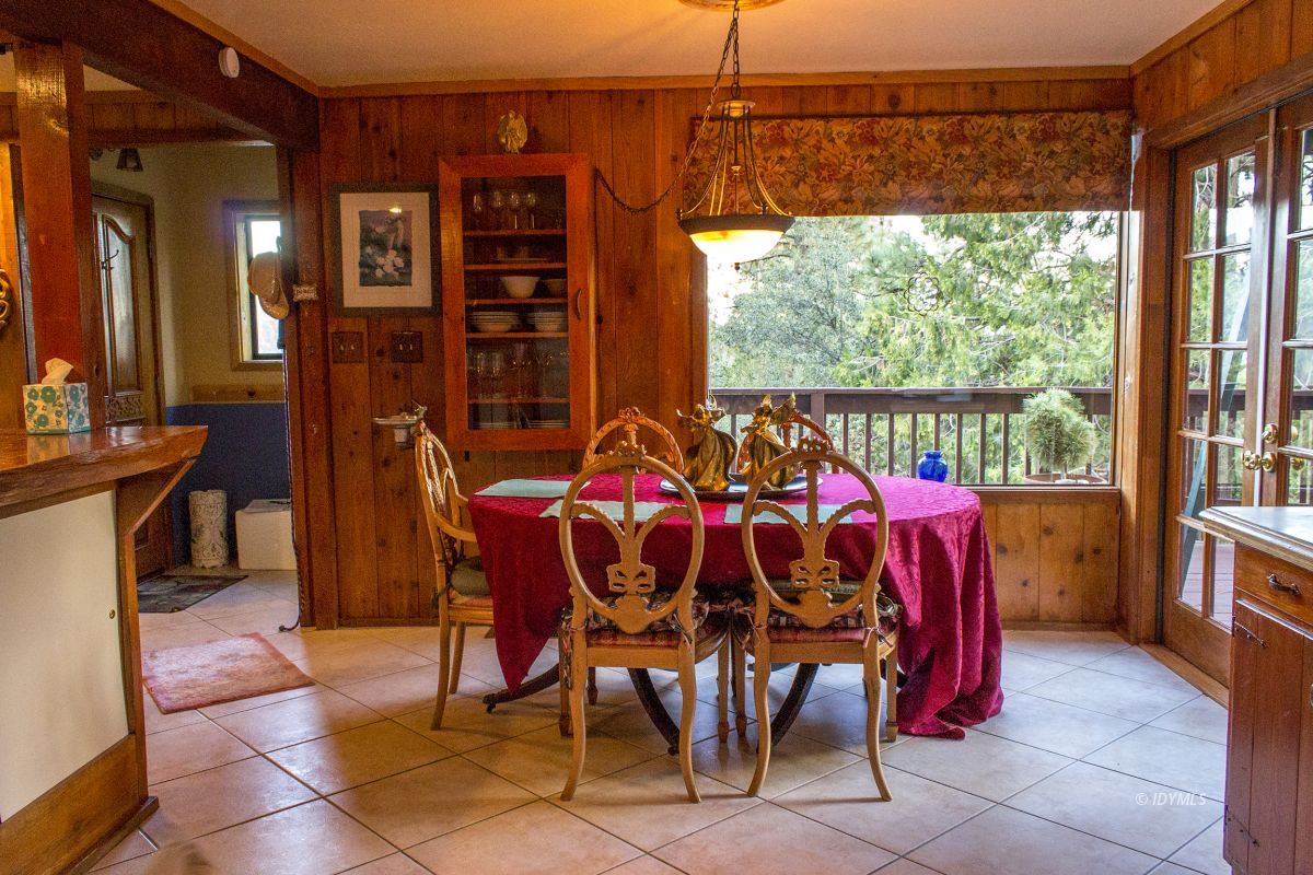 25120 Foster Lake Road Idyllwild, CA 92549 - Photo 16 of 31 a view of a dining room with furniture window and outside view