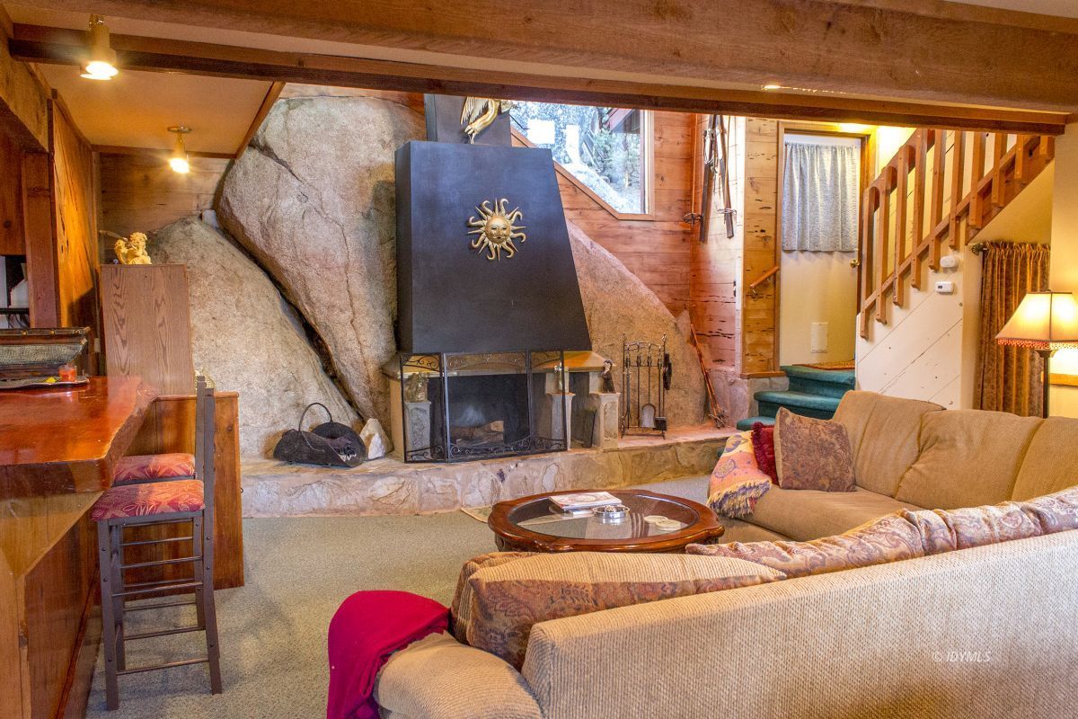 25120 Foster Lake Road Idyllwild, CA 92549 - Photo 3 of 31 a living room with furniture and a fireplace