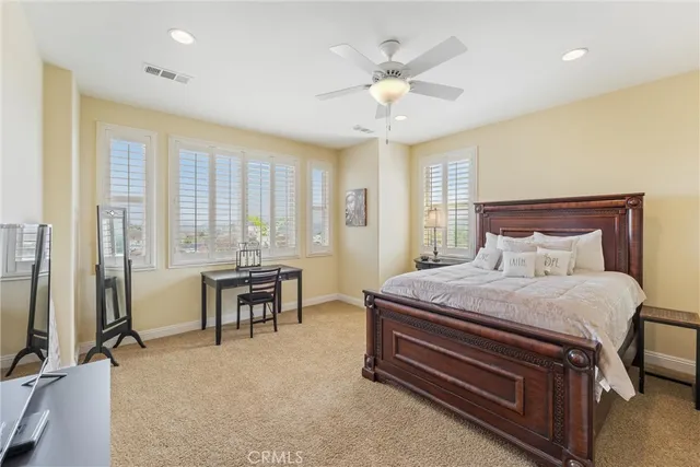 a living room with furniture a air conditioner vent and a window