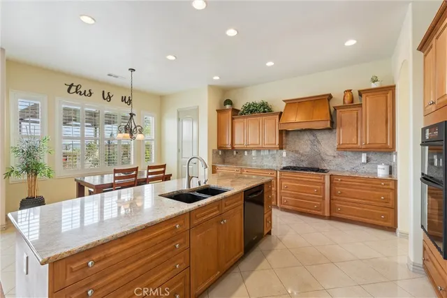 a kitchen with kitchen island granite countertop a table and chairs