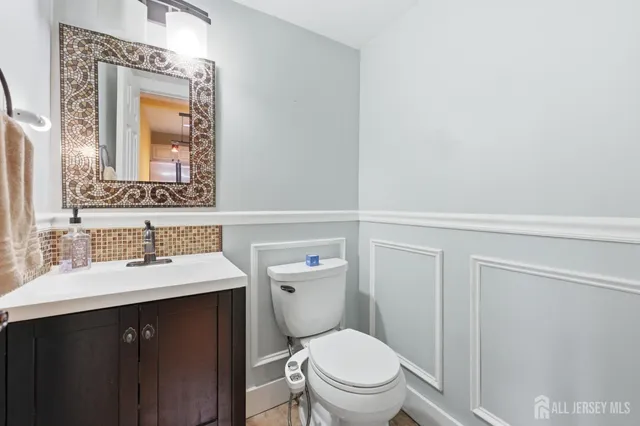 a bathroom with a sink a toilet and mirror