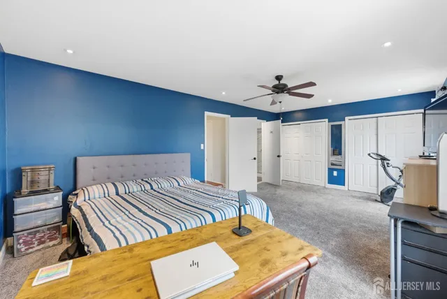 a bed room with a bed furniture and a flat screen tv