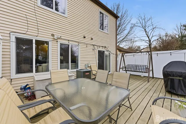 a view of a patio with couches table and chairs and wooden floor