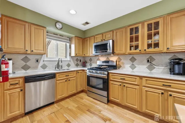 a kitchen with cabinets appliances and a sink