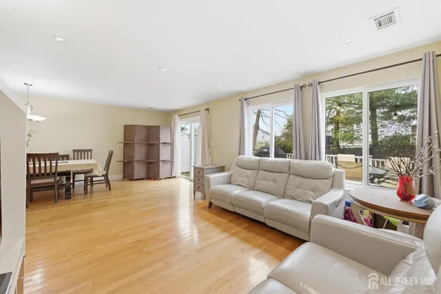 a living room with furniture and large windows