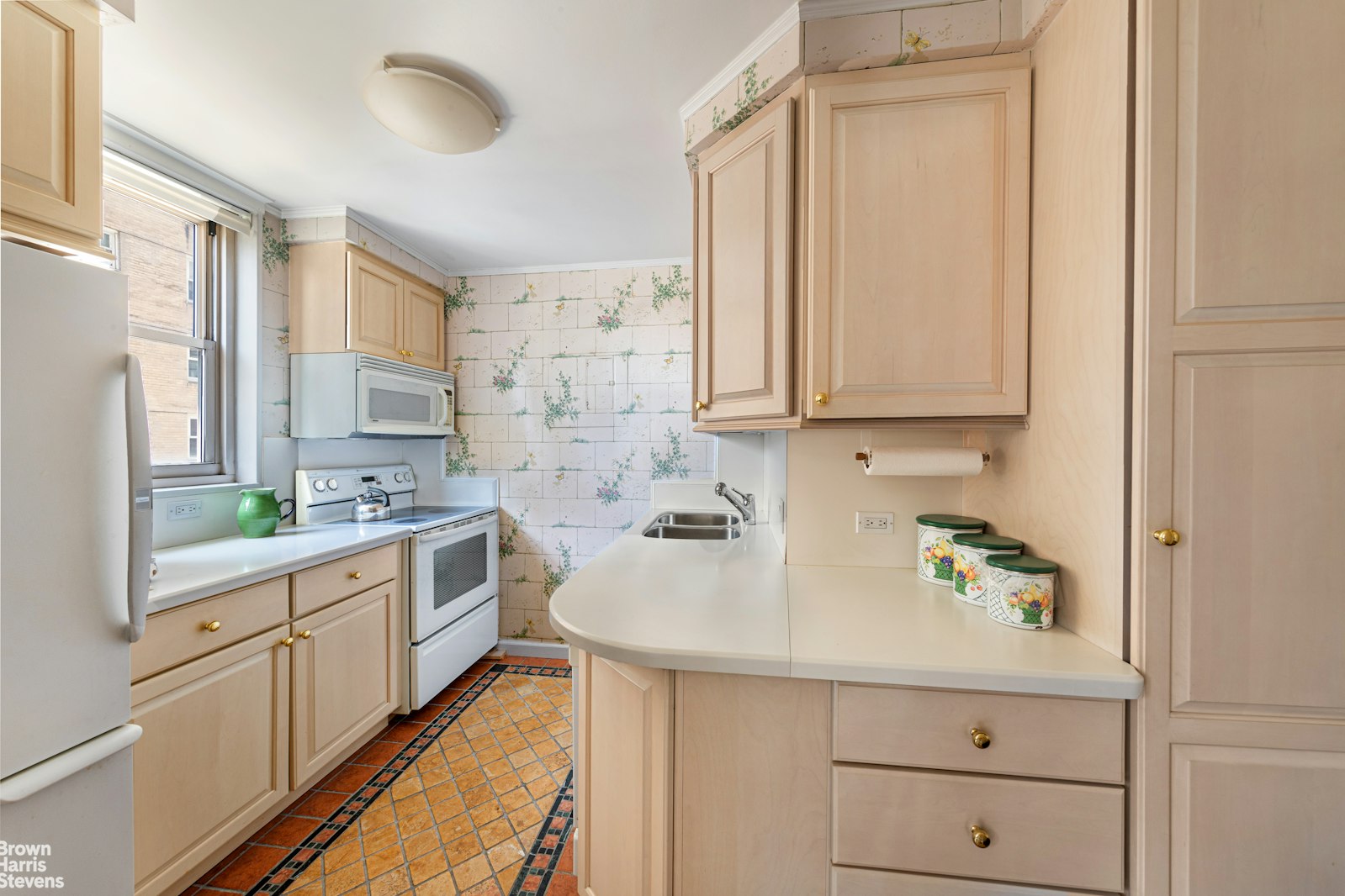137 East 36th Street, Unit 7K Manhattan, NY 10016 - Photo 19 of 30 a kitchen with white cabinets and white appliances