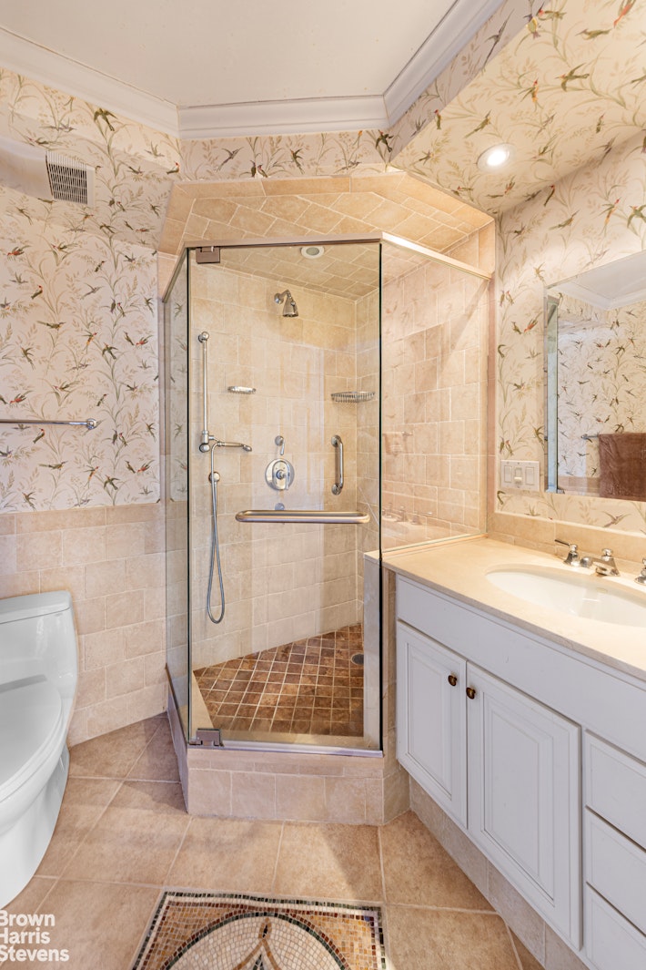 137 East 36th Street, Unit 7K Manhattan, NY 10016 - Photo 22 of 30 a bathroom with a granite countertop sink a toilet and shower