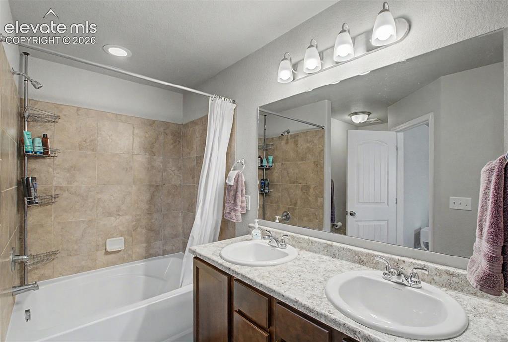 10957 Avena Road Peyton, CO 80831 - Photo 23 of 34 Primary bathroom with double vanity and soaking garden tub/shower
