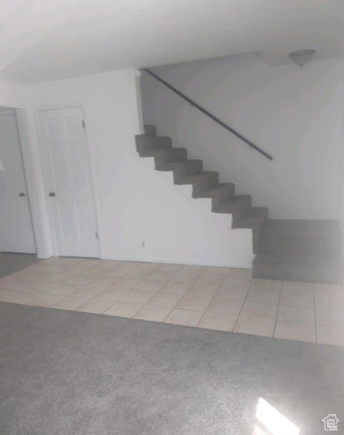 590 Pilot Avenue Wendover, UT 84083 - Photo 14 of 20 Stairway with tile patterned floors and carpet
