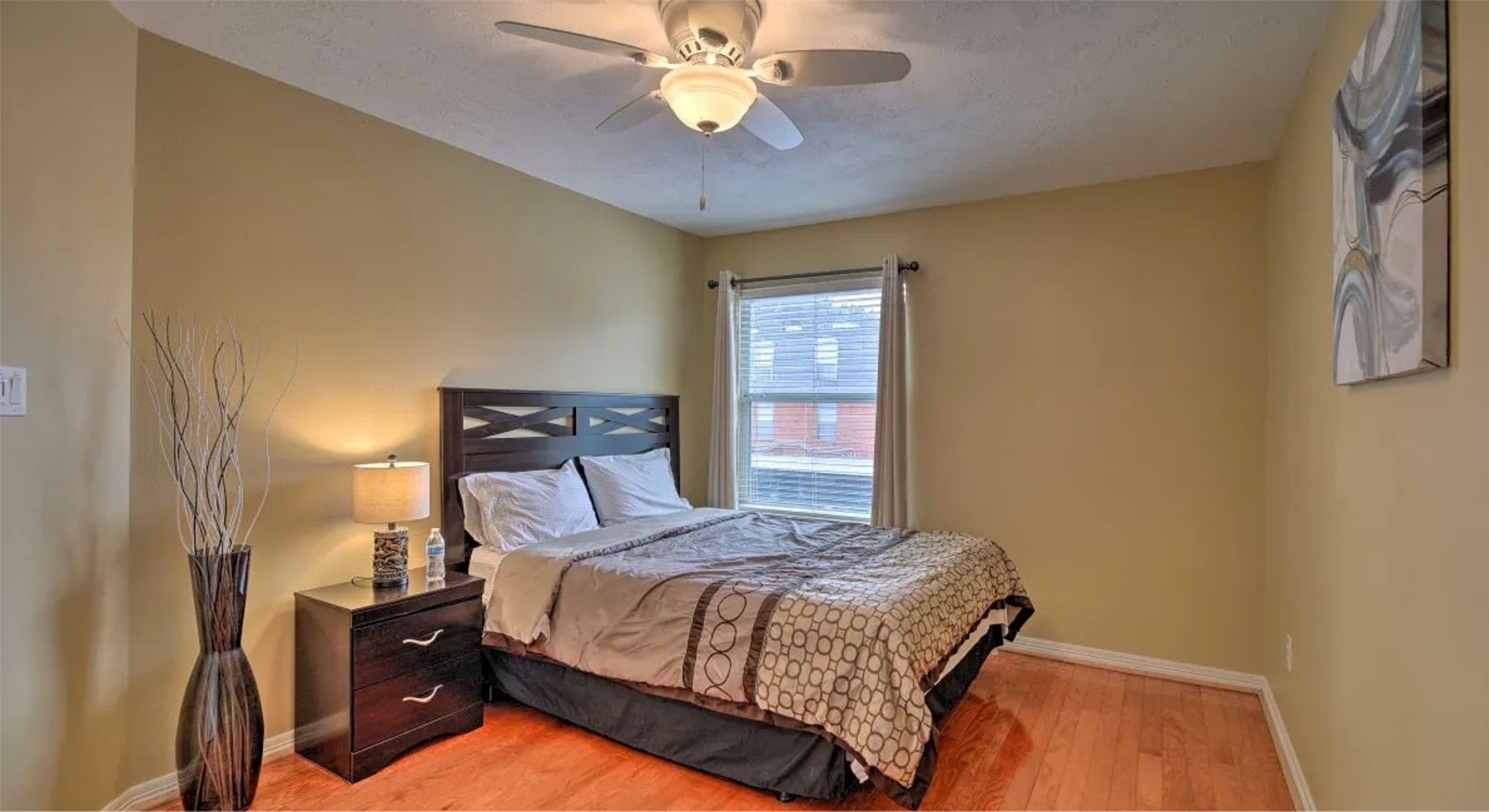 1006 Rochow Street, Unit A Houston, TX 77019 - Photo 23 of 29 a bedroom with a bed and a chandelier