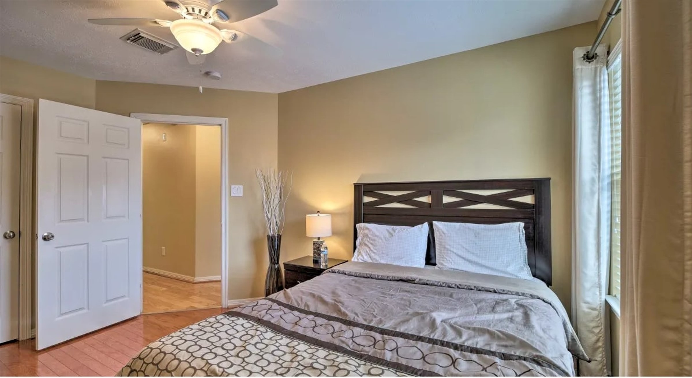 1006 Rochow Street, Unit A Houston, TX 77019 - Photo 24 of 29 a bedroom with a bed and a chandelier