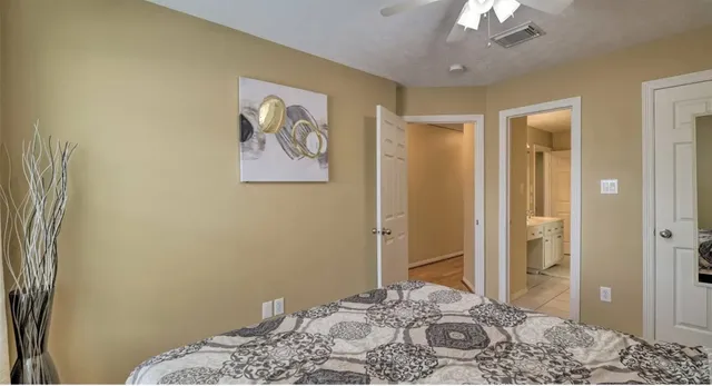 a bedroom with a bed and bathroom view