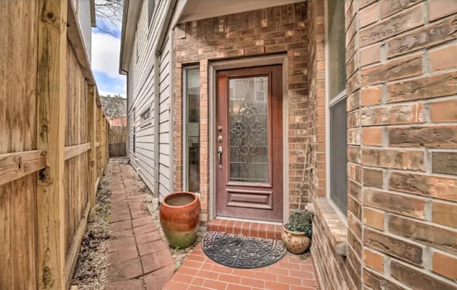 a view of a door and chair and potted plant in front of a door