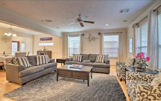 a living room with furniture and a chandelier