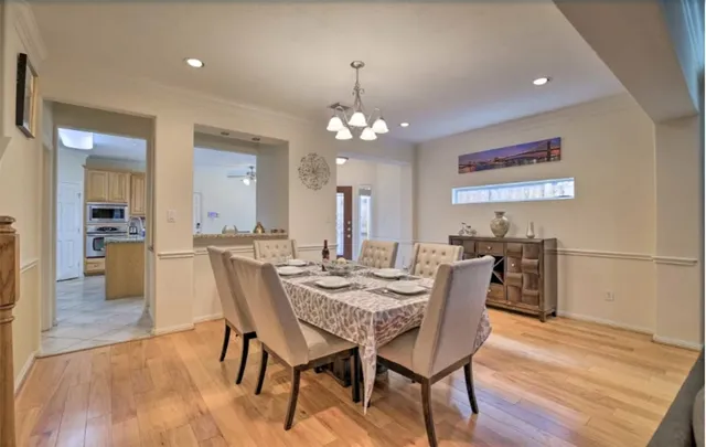 a view of a dining room with furniture and wooden floor